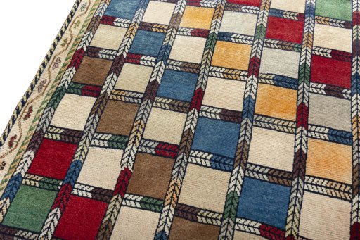 Backside of handmade 2000s Persian Gabbeh rug showing knot structure and weave density