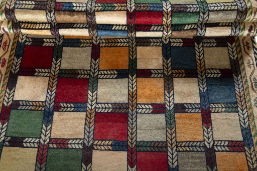Full view of 2000s Persian Gabbeh rug from Iran / Persia, 206 × 133 cm in Multi Color tones