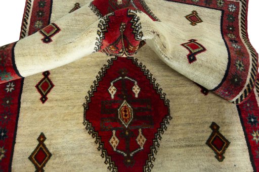 Corner detail of 2000s Persian Gabbeh rug showing border pattern and Wool pile