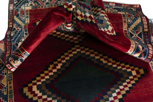 Corner detail of 2000s Persian Gabbeh rug showing border pattern and Wool pile