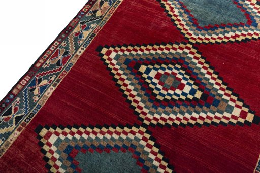 Backside of handmade 2000s Persian Gabbeh rug showing knot structure and weave density