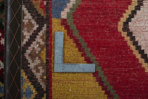 Corner detail of 2000s Persian Gabbeh rug showing border pattern and Wool pile