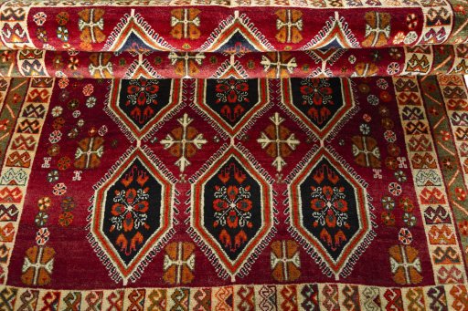 Full view of 2000s Persian Gabbeh rug from Iran / Persia, 243 × 157 cm in Red tones