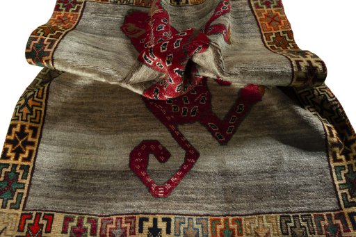 Corner detail of 2000s Persian Gabbeh rug showing border pattern and Wool pile