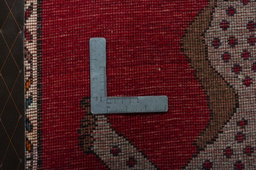 Corner detail of 2000s Persian Gabbeh rug showing border pattern and Wool pile