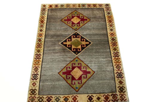 Surface texture of 2000s Persian Gabbeh rug with natural Wool and intricate pattern