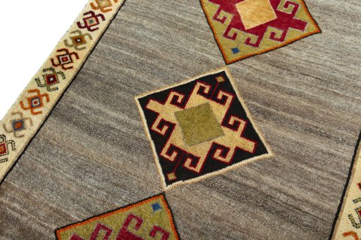Backside of handmade 2000s Persian Gabbeh rug showing knot structure and weave density