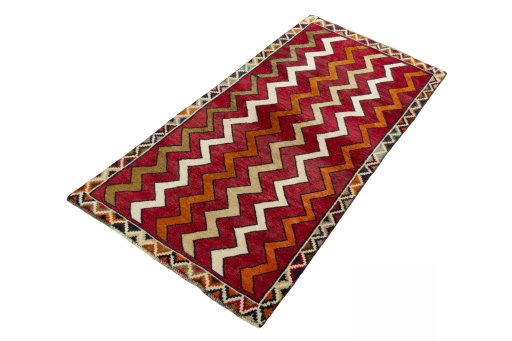Corner detail of 2000s Persian Gabbeh rug showing border pattern and Wool pile