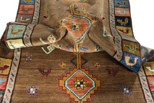 Corner detail of 2000s Persian Gabbeh rug showing border pattern and Wool pile