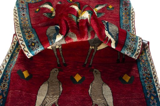 Corner detail of 2000s Persian Gabbeh rug showing border pattern and Wool pile