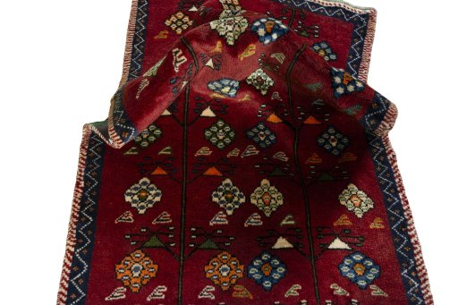 Corner detail of 2000s Persian Gabbeh rug showing border pattern and Wool pile