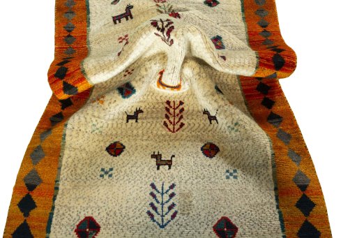 Corner detail of 2000s Persian Gabbeh rug showing border pattern and Wool pile