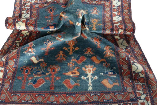 Corner detail of 2000s Persian Gabbeh rug showing border pattern and Wool pile