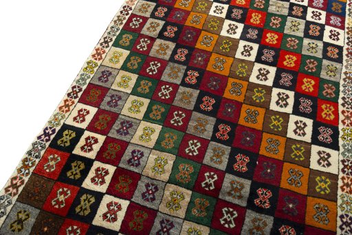 Surface texture of 2000s Persian Gabbeh rug with natural Wool and intricate pattern