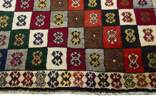 Backside of handmade 2000s Persian Gabbeh rug showing knot structure and weave density