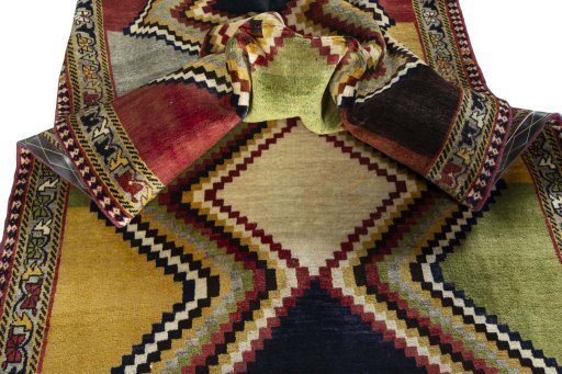 Corner detail of 2000s Persian Gabbeh rug showing border pattern and Wool pile