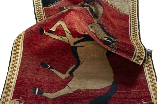 Corner detail of 2000s Persian Gabbeh rug showing border pattern and Wool pile