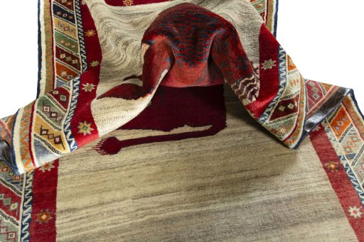 Corner detail of 2000s Persian Gabbeh rug showing border pattern and Wool pile