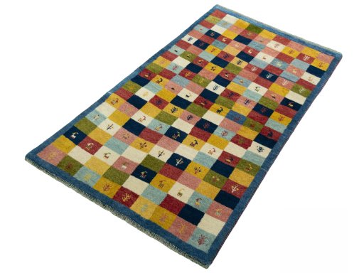 Corner detail of 2000s Persian Gabbeh rug showing border pattern and Wool pile