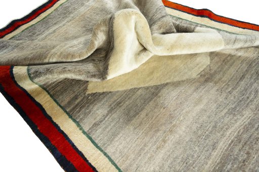 Corner detail of 2000s Persian Gabbeh rug showing border pattern and Wool pile
