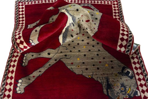 Corner detail of 2000s Persian Gabbeh rug showing border pattern and Wool pile