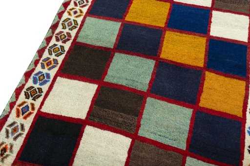 Backside of handmade 2000s Persian Gabbeh rug showing knot structure and weave density
