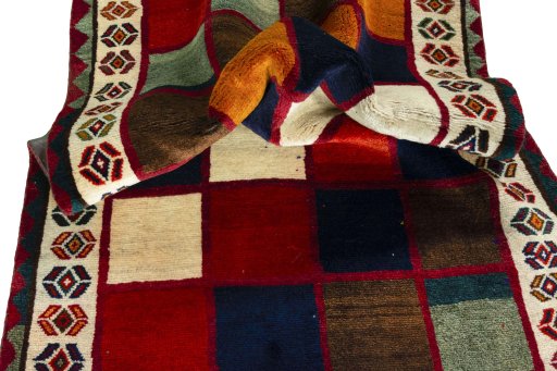 Corner detail of 2000s Persian Gabbeh rug showing border pattern and Wool pile