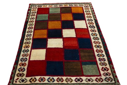 Surface texture of 2000s Persian Gabbeh rug with natural Wool and intricate pattern