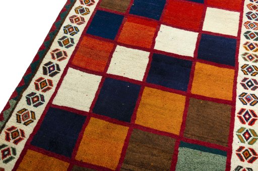 Backside of handmade 2000s Persian Gabbeh rug showing knot structure and weave density