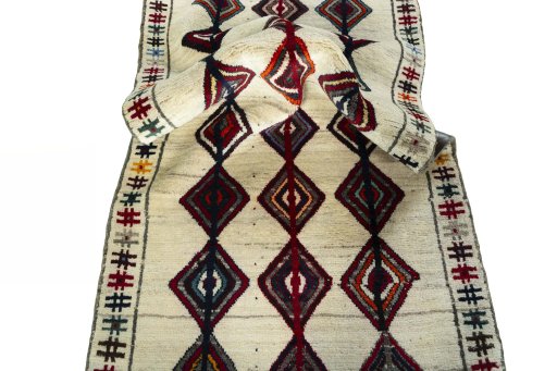Corner detail of 2000s Persian Gabbeh rug showing border pattern and Wool pile