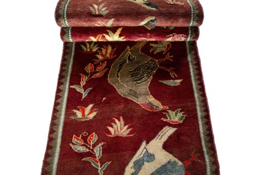 Full view of 2000s Persian Gabbeh rug from Iran / Persia, 323 × 83 cm in Red tones