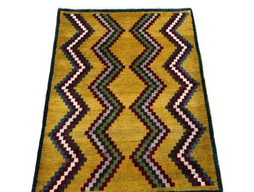 Surface texture of 2000s Persian Gabbeh rug with natural Wool and intricate pattern