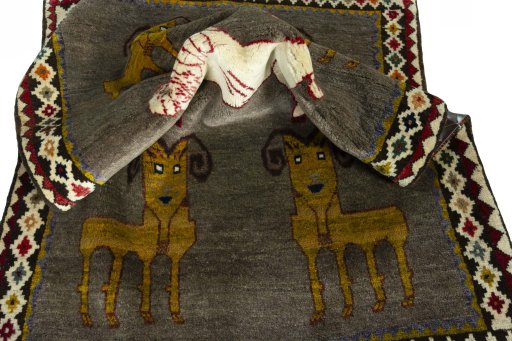 Corner detail of 2000s Persian Gabbeh rug showing border pattern and Wool pile
