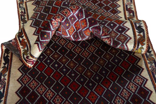 Corner detail of 2000s Persian Gabbeh rug showing border pattern and Wool pile
