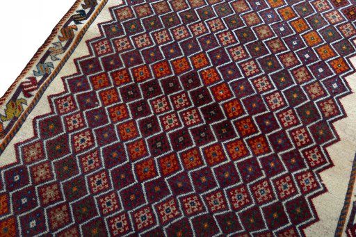 Backside of handmade 2000s Persian Gabbeh rug showing knot structure and weave density