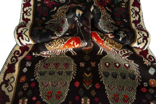 Corner detail of 2000s Persian Gabbeh rug showing border pattern and Wool pile