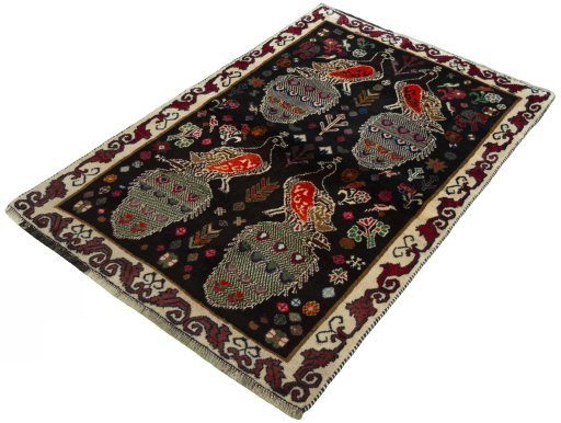 Corner detail of 2000s Persian Gabbeh rug showing border pattern and Wool pile