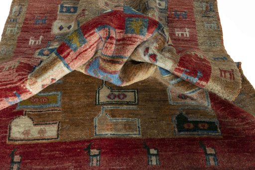 Corner detail of 2000s Persian Gabbeh rug showing border pattern and Wool pile