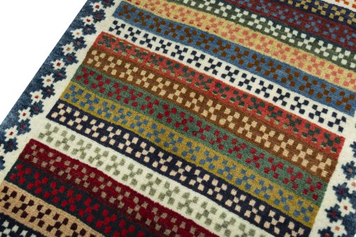 Backside of handmade 2000s Persian Gabbeh rug showing knot structure and weave density