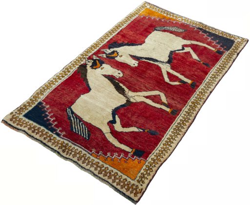 Corner detail of 2000s Persian Gabbeh rug showing border pattern and Wool pile