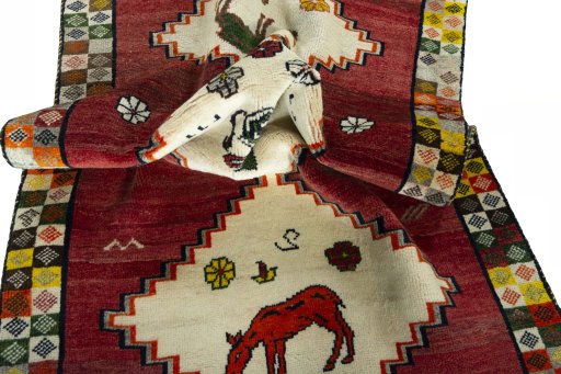 Corner detail of 2000s Persian Gabbeh rug showing border pattern and Wool pile