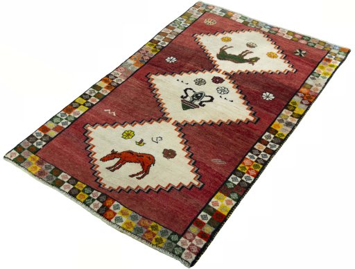 Corner detail of 2000s Persian Gabbeh rug showing border pattern and Wool pile