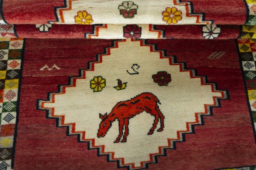 Full view of 2000s Persian Gabbeh rug from Iran / Persia, 155 × 100 cm in Red tones