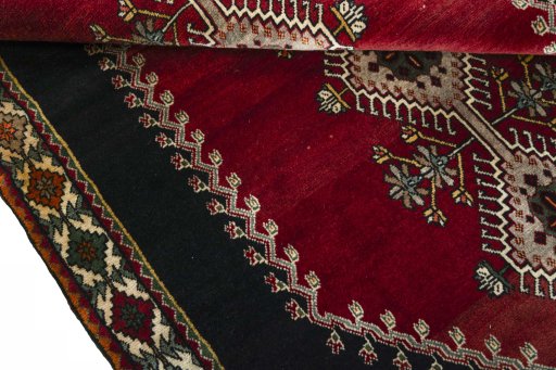 Corner detail of 2000s Persian Gabbeh rug showing border pattern and Wool pile
