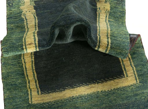 Corner detail of 2000s Persian Gabbeh rug showing border pattern and Wool pile
