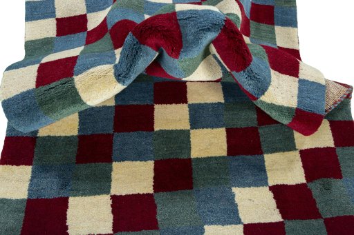 Corner detail of 2000s Persian Gabbeh rug showing border pattern and Wool pile
