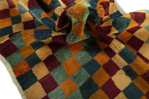 Corner detail of 2000s Persian Gabbeh rug showing border pattern and Wool pile