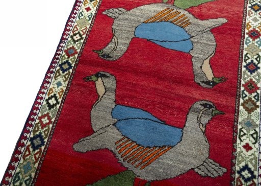 Backside of handmade 2000s Persian Gabbeh rug showing knot structure and weave density