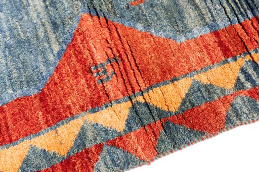 Backside of handmade 1975s Persian Gabbeh rug showing knot structure and weave density
