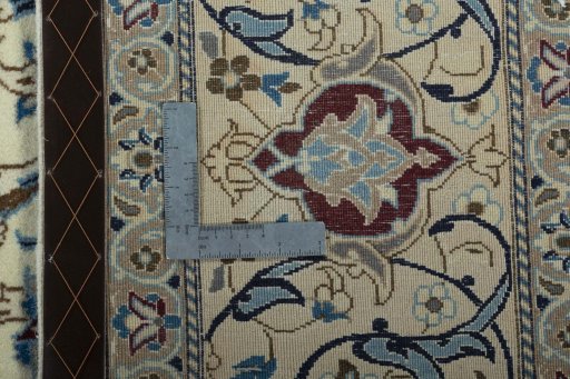 Backside of handmade 2000s Nain rug showing knot structure and weave density